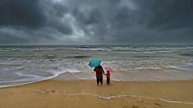 A woman stands with her son at Marina beach following heavy downpour due to the onset of Northeast monsoon in Chennai. More than 10,000 fishermen stayed in port Saturday as the sea remained very rough with waves rising to several feet (PTI) A woman stands with her son at Marina beach following heavy downpour due to the onset of Northeast monsoon in Chennai. More than 10,000 fishermen stayed in port Saturday as the sea remained very rough with waves rising to several feet (PTI)