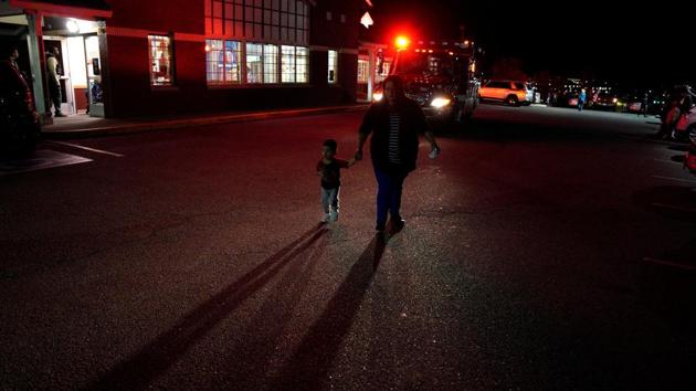 A woman walks past an ambulance near the scene of the shooting at a Walmart in Thornton. Guadalupe Perez was inside the store with her young son when she heard what she thought was a balloon popping. An employee told her someone was shooting, and then Perez saw people running away yelling, ‘Let’s go. Let’s go. Leave the groceries.’ (Rick Wilking / REUTERS) A woman walks past an ambulance near the scene of the shooting at a Walmart in Thornton. Guadalupe Perez was inside the store with her young son when she heard what she thought was a balloon popping. An employee told her someone was shooting, and then Perez saw people running away yelling, ‘Let’s go. Let’s go. Leave the groceries.’ (Rick Wilking / REUTERS)