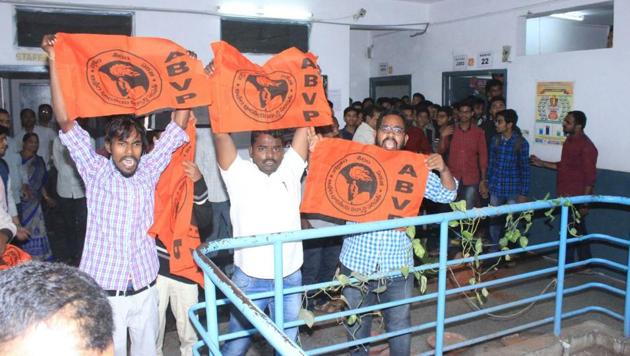 ABVP activists hold up banners after vandalising the premises of Narayana College in Hyderabad.(HT Photo)