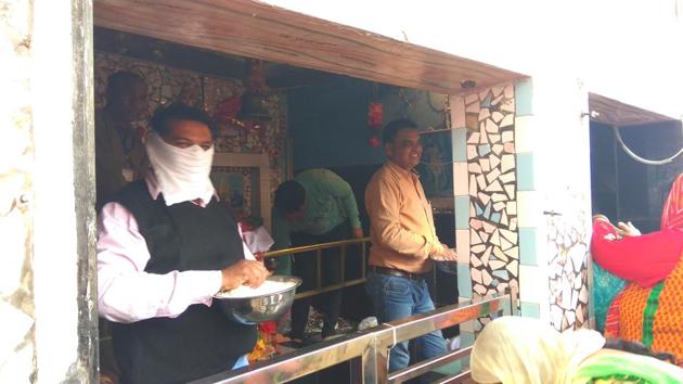A teacher distributing prashad at one of the temples during the Kapal Mochan Mela in Yamunanagar (HT Photo) A teacher distributing prashad at one of the temples during the Kapal Mochan Mela in Yamunanagar (HT Photo)