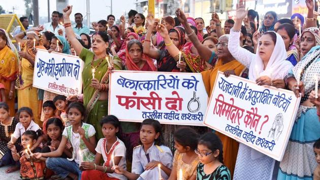 Mahila Congress activists with children during a candle light protest against the alleged gang rape of a student in Bhopal on Friday. (PTI Photo) Mahila Congress activists with children during a candle light protest against the alleged gang rape of a student in Bhopal on Friday. (PTI Photo)