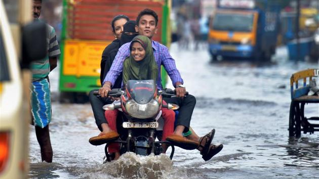 A motorcyclist wades through a flooded street in an inundated locality after heavy incessant rains due to the onset of North East Monsoon in Chennai on Tuesday. (PTI Photo) A motorcyclist wades through a flooded street in an inundated locality after heavy incessant rains due to the onset of North East Monsoon in Chennai on Tuesday. (PTI Photo)