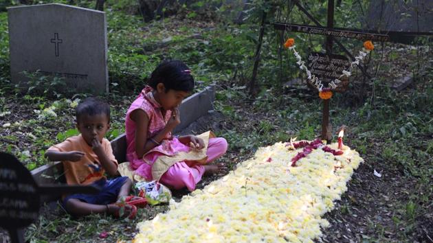 Children pay respects to the departed at the St. Sepulchre cemetery on Thursday, as Christians in the city marked November 2 as All Souls Day. (RAHUL RAUT/HT PHOTO)