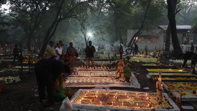 Families, relatives and friends pay respects to the departed at the St. Sepulchre cemetery on Thursday, as Christians in the city marked November 2 as All Souls Day. (RAHUL RAUT/HT PHOTO)