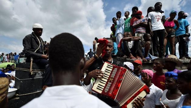 Voodoo followers take part in Day of the Dead celebrations in the Cemetery of Cite Soleil, in Port-au-Prince. Voodoo is practiced in Haiti and by its diaspora, with roots in West African religions that underwent syncretism with local traditions and Christianity under colonial rule as a means of preserving culture. (Hector Retamal / AFP) Voodoo followers take part in Day of the Dead celebrations in the Cemetery of Cite Soleil, in Port-au-Prince. Voodoo is practiced in Haiti and by its diaspora, with roots in West African religions that underwent syncretism with local traditions and Christianity under colonial rule as a means of preserving culture. (Hector Retamal / AFP)