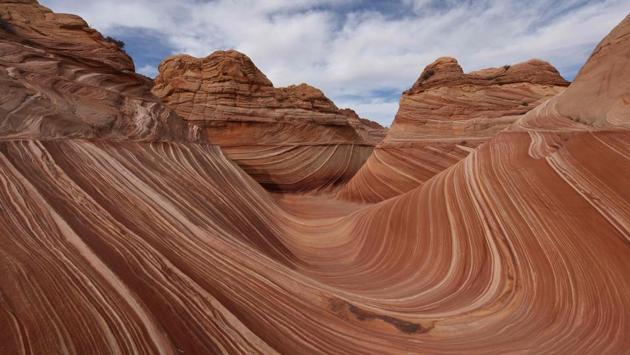 The unique U-shaped troughs of ‘The Wave’ rock formation are seen at the Coyote Buttes North wilderness area near Page, Arizona. The Wave is a sandstone rock formation in northern Arizona and was formed by a combination of water and wind erosion and due to its fragile nature; access is limited to only 20 hikers per day. (Mark Ralston / AFP) The unique U-shaped troughs of ‘The Wave’ rock formation are seen at the Coyote Buttes North wilderness area near Page, Arizona. The Wave is a sandstone rock formation in northern Arizona and was formed by a combination of water and wind erosion and due to its fragile nature; access is limited to only 20 hikers per day. (Mark Ralston / AFP)