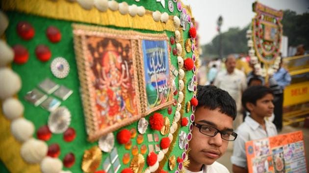 A boy carries a decorated pankha during the Phool Walon ki Sair in New Delhi. The Sair began as fulfilment of Queen Mumtaz Mahal Begum’s vow to walk to the shrine of Hazrat Qutubuddin Bakhtiyar Kaki in Mehrauli for the return of her son Mirza Jahangir from exile, who shot at the British Resident Sir Archibald Seton on his disapproval of the emperor’s choice of Jahangir as heir apparent over Bahadur Shah Zafar II. (Sanchit Khanna / HT Photo) A boy carries a decorated pankha during the Phool Walon ki Sair in New Delhi. The Sair began as fulfilment of Queen Mumtaz Mahal Begum’s vow to walk to the shrine of Hazrat Qutubuddin Bakhtiyar Kaki in Mehrauli for the return of her son Mirza Jahangir from exile, who shot at the British Resident Sir Archibald Seton on his disapproval of the emperor’s choice of Jahangir as heir apparent over Bahadur Shah Zafar II. (Sanchit Khanna / HT Photo)