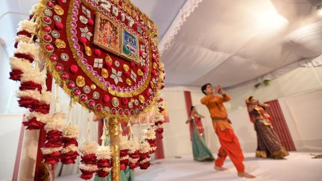 A cultural performance is underway behind the iconic pankha of the Phool Walon ki Sair at Yogmaya Temple. Troupes representing the states of India come in a procession holding pankhas and perform on stage during festivities. The e programme this year also features a qawwali performance by Rais Anis Sabri and Yusuf Malik at Jahaz Mahal. (Sanchit Khanna / HT Photo) A cultural performance is underway behind the iconic pankha of the Phool Walon ki Sair at Yogmaya Temple. Troupes representing the states of India come in a procession holding pankhas and perform on stage during festivities. The e programme this year also features a qawwali performance by Rais Anis Sabri and Yusuf Malik at Jahaz Mahal. (Sanchit Khanna / HT Photo)