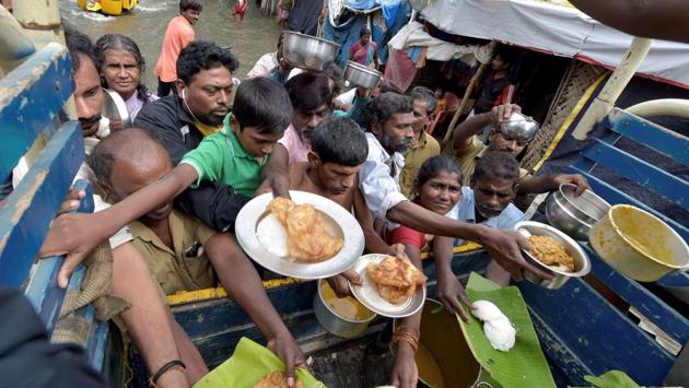 Volunteers distributed food packets and water in affected areas of Nanmangalam and Pallikaranai to residents as rain persisted for the fifth day in Chennai on Friday. A government statement said over 10,000 people were living in 105 state-run relief camps as rains flooded low-lying areas in Chennai and its suburbs on Thursday and Friday. (PTI) Volunteers distributed food packets and water in affected areas of Nanmangalam and Pallikaranai to residents as rain persisted for the fifth day in Chennai on Friday. A government statement said over 10,000 people were living in 105 state-run relief camps as rains flooded low-lying areas in Chennai and its suburbs on Thursday and Friday. (PTI)
