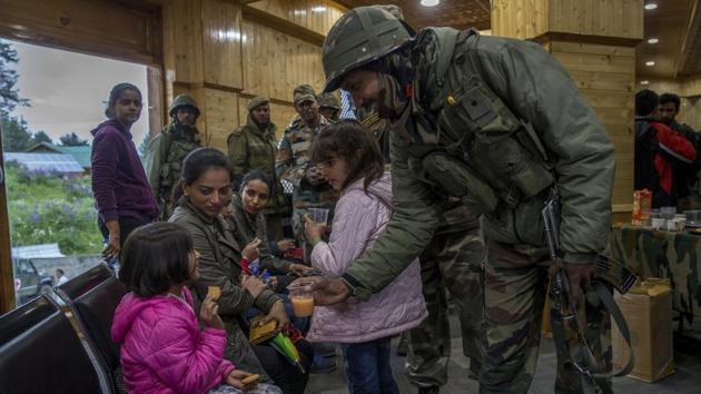 An army soldier offers juice to a child after she was rescued from a cable car in Gulmarg, Kashmir, in June 2017. The army was called in to help with rescue efforts after a cable car came crashing down from a height of at least 100 feet in the tourist resort of Gulmarg, leaving scores of tourists stranded.(AP File Photo) An army soldier offers juice to a child after she was rescued from a cable car in Gulmarg, Kashmir, in June 2017. The army was called in to help with rescue efforts after a cable car came crashing down from a height of at least 100 feet in the tourist resort of Gulmarg, leaving scores of tourists stranded.(AP File Photo)