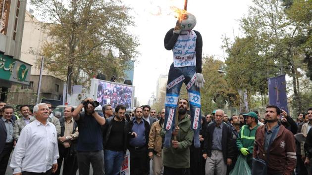 Iranians burn a doll representing Israel and America during a demonstration outside the former US embassy in the Iranian capital Tehran on November 4, 2017, marking the anniversary of its storming by student protesters that triggered a hostage crisis in 1979.(AFP)