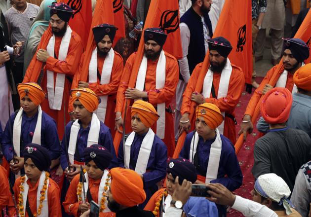 Devotees in traditional attire attending the religious festivities to celebrate the 549th birth anniversary of Guru Nanak Dev at Nankana Sahib. (AP)