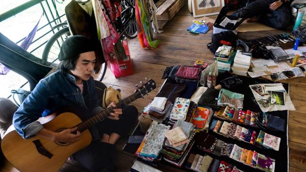 A man strums a guitar at a once-a-month ex lover's (Old Flames) market in Hanoi.(AFP)