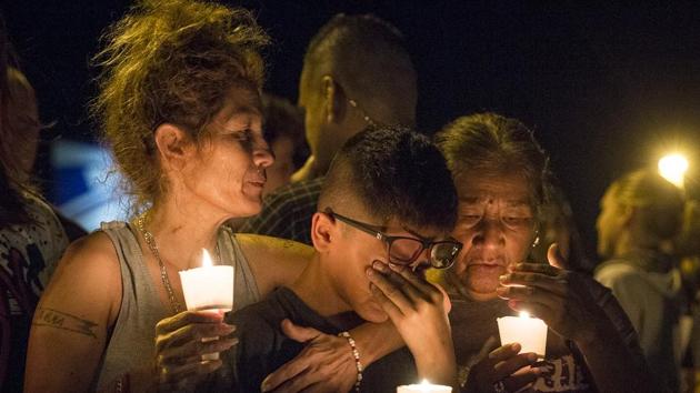 A resident of Sutherland Springs Mona Rodriguez holds her 12-year-old son during a candlelight vigil held for the victims of a fatal shooting at the First Baptist Church in Texas on Sunday. (AP) A resident of Sutherland Springs Mona Rodriguez holds her 12-year-old son during a candlelight vigil held for the victims of a fatal shooting at the First Baptist Church in Texas on Sunday. (AP)