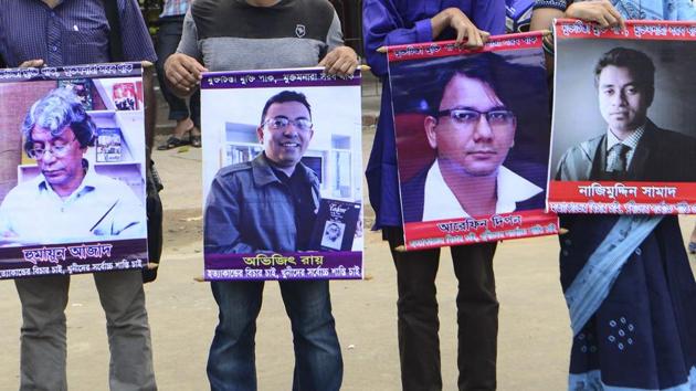 Bangladeshi activists hold the photos of activists, writers and bloggers ((L-R) Humayun Azad, Avijit Roy, Faisal Arefin Dipan, Nazimuddin Samad) who were murdered by unidentified assassins in the last few years, in Dhaka on June 15, 2016.(AFP File Photo)