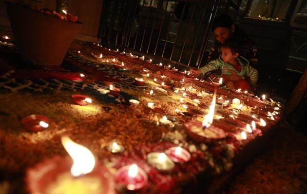 A kid lights a diya (earthen lamp) as part of Deepotsav on the occasion of Tripurari Pornima at Mahalaxmi temple near Sarasbaug in Pune on November 3, 2017. (Rahul Raut/HT PHOTO) A kid lights a diya (earthen lamp) as part of Deepotsav on the occasion of Tripurari Pornima at Mahalaxmi temple near Sarasbaug in Pune on November 3, 2017. (Rahul Raut/HT PHOTO)