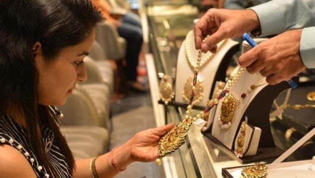 A shopper looks for gold jewellery and ornaments during Dhanteras at a jewellery store in Amritsar on October 17, 2017. (AFP File Photo) A shopper looks for gold jewellery and ornaments during Dhanteras at a jewellery store in Amritsar on October 17, 2017. (AFP File Photo)