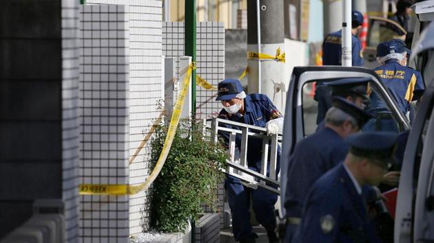 Policemen prepare for inspection in front of an apartment in Zama, Kanagawa prefecture, on November 2, where police found nine dismembered corpses. (AFP) Policemen prepare for inspection in front of an apartment in Zama, Kanagawa prefecture, on November 2, where police found nine dismembered corpses. (AFP)