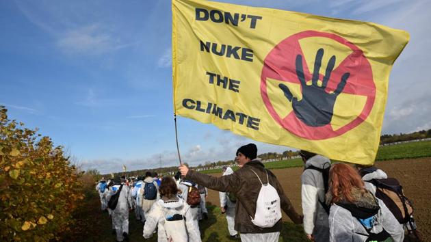 Environmentalist march close to the Hambach lignite open pit mine near Elsdorf, western Germany, on Sunday, as they protest against fossil-based energies like coal, having negative impact on the climate change. (AFP) Environmentalist march close to the Hambach lignite open pit mine near Elsdorf, western Germany, on Sunday, as they protest against fossil-based energies like coal, having negative impact on the climate change. (AFP)