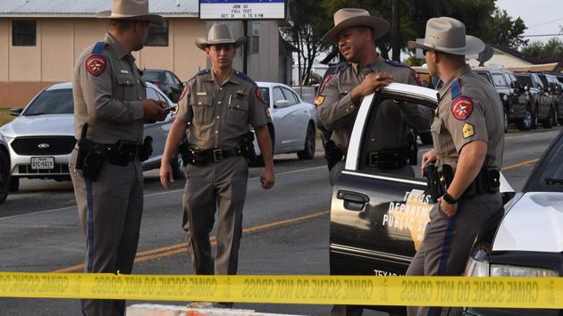 State troopers guard the entrance to the First Baptist Church (back) after a mass shooting that killed 26 people in Sutherland Springs, Texas on November 6. (AFP) State troopers guard the entrance to the First Baptist Church (back) after a mass shooting that killed 26 people in Sutherland Springs, Texas on November 6. (AFP)