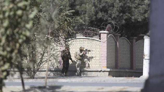 Afghan security personnel take position near the Shamshad TV station after an attack in Kabul, Afghanistan, on Tuesday.(AP)