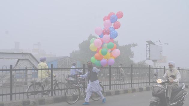 Trying to brighten things up, a vendor sells balloons during ‘smoggy’ weather in Amritsar on Tuesday. (Sameer Sehgal/HT)
