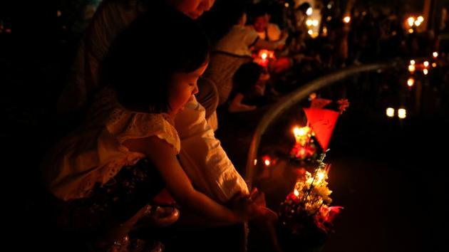 A girl casts a krathong into a pond at a public park during the Loy Krathong festival. Chiang Mai is considered as one of the best places to experience the Loy Krathong festival in Thailand which is celebrated on the first full moon of the 12th traditional Thai calendar and which includes a themed float parade through the town. (Jorge Silva / REUTERS)