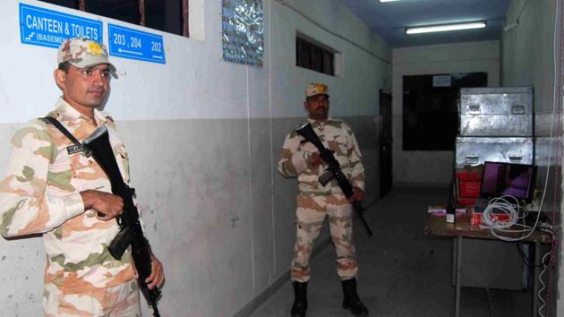 Security personnel stand outside the strong room where election material is kept for dispatching to the election booths, in Shimla. (Deepak Sansta /HT Photo) Security personnel stand outside the strong room where election material is kept for dispatching to the election booths, in Shimla. (Deepak Sansta /HT Photo)