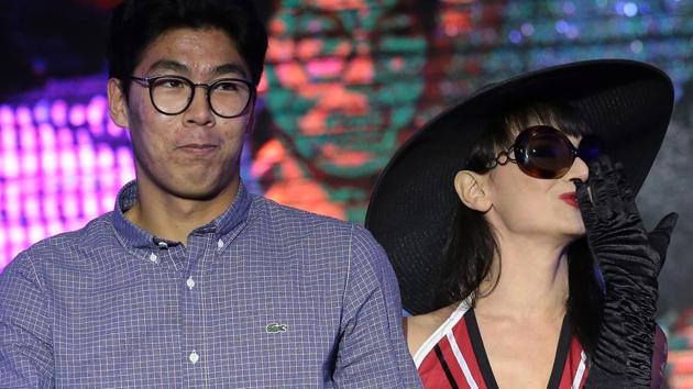 South Korean player Hyeon Chung looked visibly embarrassed as he was asked to pull off a female model’s glove with his teeth. (Getty Images)