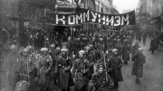 Armed soldiers carry a banner reading ‘Communism’ as they march along Nikolskaya Street towards to the Kremlin Wall in Moscow, Russia. In a counter to Bolshevik appeals, Commander-in Chief General Lavr Kornilov marched with troops to restore order in Petrograd but the movement was halted by the Bolshevik influence on railroad and telegraph workers. (Russian State Documentary Film and Photo Archive via AP)