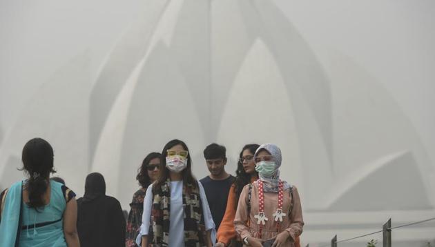 NTourists wear masks while visiting the Lotus Temple in New Delhi. (Burhaan Kinu/HT Photo) NTourists wear masks while visiting the Lotus Temple in New Delhi. (Burhaan Kinu/HT Photo)
