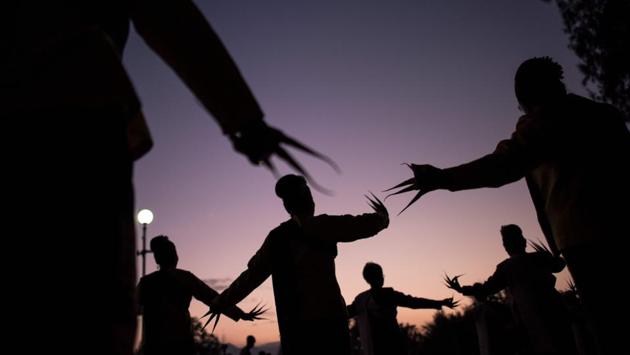Dancers perform a traditional Thai brass finger nail dance as they celebrate the Yee Peng festival, out of respect for the late monarch, authorities in the capital said. (Roberto Schmidt / AFP)