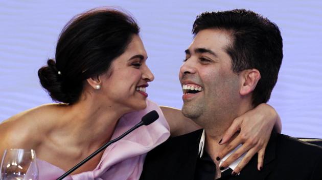 Actor Deepika Padukone hugs Bollywood producer Karan Johar during a session of the Hindustan Times Leadership Summit 2014 in New Delhi. (Gurinder Osan/HT FIle Photo)
