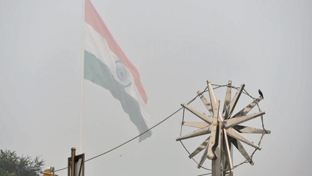 A view of the steel ''Charkha'', installed at Rajiv Chowk, enveloped by heavy smog in New Delhi on Wednesday.(PTI)