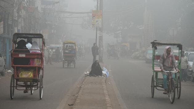 A homeless person sits on a road median amid heavy smog in New Delhi. (AFP) A homeless person sits on a road median amid heavy smog in New Delhi. (AFP)