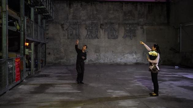 A security person guides a woman at a garage outside Ultraviolet restaurant in Shanghai. Chef Pairet says the rising consumer interest also indicates the growing disposable income and culinary curiosity of Shanghai citizens. He points out that demand among Chinese eaters actually increased after he hiked up Ultraviolet’s prices to sustain the project. (Chandan Khanna / AFP) 