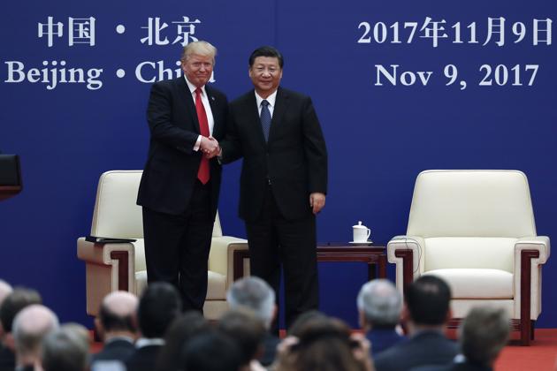 US President Donald Trump and his Chinese counterpart Xi Jinping shake hands at the Great Hall of the People in Beijing on November 9, 2017. (AP) US President Donald Trump and his Chinese counterpart Xi Jinping shake hands at the Great Hall of the People in Beijing on November 9, 2017. (AP)