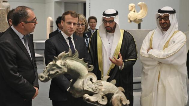 French President Emmanuel Macron, (2nd left), and Abu Dhabi Crown Prince Mohammed bin Zayed al-Nahayan, (R), visit the Louvre Abu Dhabi Museum during its inauguration. The opening comes a decade after France and the UAE signed a 30-year partnership reported to be worth $1.1 billion, including nearly half a billion dollars for the rights to the Louvre tag alone. Louvre Abu Dhabi is the first museum beyond France to bear the Louvre badge. (Ludovic Marin / Pool photo via AP)