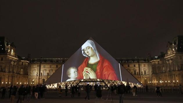 Pictures are projected on the Pyramid of the Louvre in Paris, celebrating the opening of the Louvre Abu Dhabi. The museum expects to welcome around 5,000 visitors in the first few days following the public opening on November 11. Jean-Luc Martinez, president-director of the Louvre in Paris described it as a bridge between Asia, Africa and Europe. “It’s a place to see the world from Abu Dhabi.” (Christophe Ena / AP)