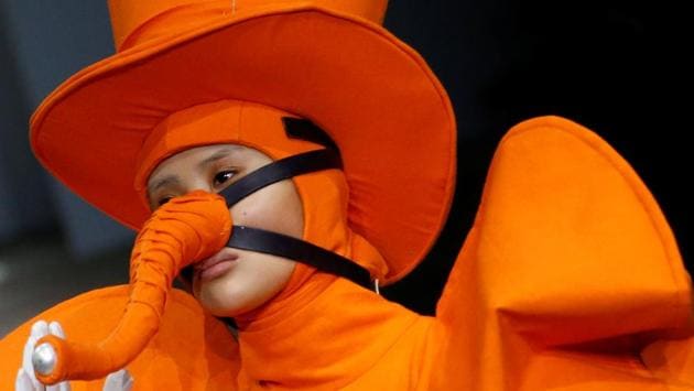 Hu Sheguang got his models to walk down the runway in exaggerated hats of various sizes, shapes and outrageous styles. (Thomas Peter / Reuters ) Hu Sheguang got his models to walk down the runway in exaggerated hats of various sizes, shapes and outrageous styles. (Thomas Peter / Reuters )