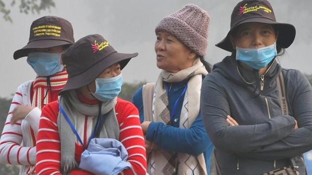 Tourists wear masks to protect themselves from heavy smog and air pollution in New Delhi on Thursday. (PTI Photo) Tourists wear masks to protect themselves from heavy smog and air pollution in New Delhi on Thursday. (PTI Photo)