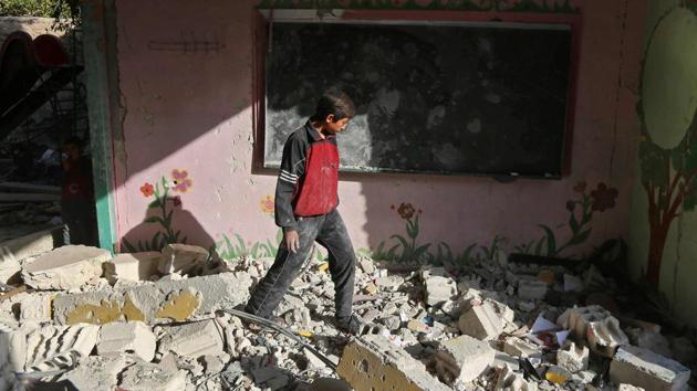 A Syrian boy walks amid the rubble inside his damaged school on Thursday in the besieged rebel-held Eastern Ghouta town of Hamouria, on the outskirts of the Syrian capital Damascus, following air raids by government forces on the area the previous day. (AFP Photo) A Syrian boy walks amid the rubble inside his damaged school on Thursday in the besieged rebel-held Eastern Ghouta town of Hamouria, on the outskirts of the Syrian capital Damascus, following air raids by government forces on the area the previous day. (AFP Photo)