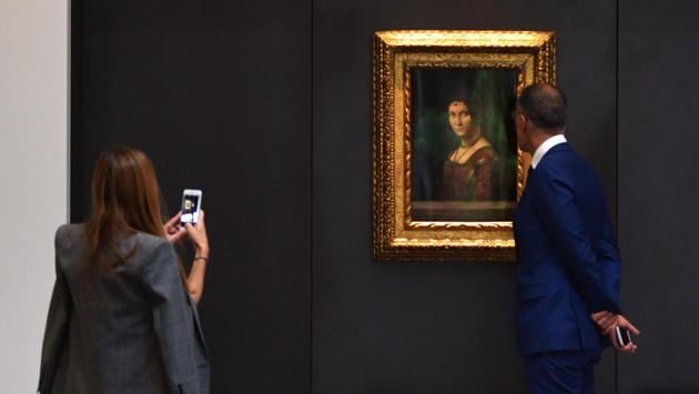 Visitors look at a painting titled “La Belle Ferroniere” by Leonardo Da Vinci at the Louvre Abu Dhabi. It also has around 300 pieces on loan, including an 1887 self-portrait by Vincent van Gogh and Da Vinci’s painting pictured above. (Guiseppe Cacace / AFP)