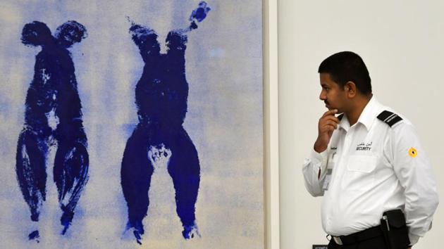 A security guard looks at “Untitled Anthropometry Ant 110” by artist Yves Klein at the Louvre Abu Dhabi Museum. The authorities have put in place strict measures to protect the art from the heat in a country where summer temperatures soar well above 40 degrees Celsius. (Guiseppe Cacace / AFP)