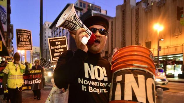 Activists protesting the one year anniversary of the election of US President Donald Trump march through downtown Los Angeles, California on Wednesday. (AFP) Activists protesting the one year anniversary of the election of US President Donald Trump march through downtown Los Angeles, California on Wednesday. (AFP)