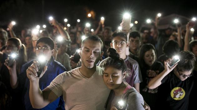 Matthew Mata and Erika Gonzalez participate in a memorial service for the victims of Sunday's church shooting in Sutherland Springs, Texas on November 6, 2017. The gunman of the deadly shooting had a history of domestic violence and sent threatening text messages to his mother-in-law, a member of First Baptist, before the attack in which he fired at least 450 rounds at helpless worshippers, authorities said Monday. (Jay Janner / Austin American-Statesman via AP) Matthew Mata and Erika Gonzalez participate in a memorial service for the victims of Sunday's church shooting in Sutherland Springs, Texas on November 6, 2017. The gunman of the deadly shooting had a history of domestic violence and sent threatening text messages to his mother-in-law, a member of First Baptist, before the attack in which he fired at least 450 rounds at helpless worshippers, authorities said Monday. (Jay Janner / Austin American-Statesman via AP)