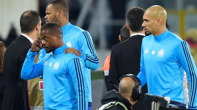 Patrice Evra (L) is escorted off the pitch by teammates Rolando and Doria (R) after an argument with Marseille supporters. (AFP) Patrice Evra (L) is escorted off the pitch by teammates Rolando and Doria (R) after an argument with Marseille supporters. (AFP)