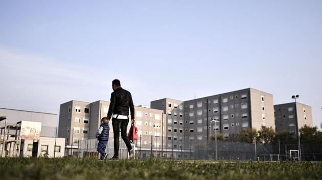 A man holds the hand of a child on their way to the nursery in Bollate Penitentiary. The idea of sending children to the prison had parents apprehensive at first but understanding the project changed minds. “Even if it is a prison creche, you don’t need to actually go into the prison or through any controls,” Federica Ridolfi a local mother said, explaining that the nursery has its own entry. (Marco Bertorello / AFP) A man holds the hand of a child on their way to the nursery in Bollate Penitentiary. The idea of sending children to the prison had parents apprehensive at first but understanding the project changed minds. “Even if it is a prison creche, you don’t need to actually go into the prison or through any controls,” Federica Ridolfi a local mother said, explaining that the nursery has its own entry. (Marco Bertorello / AFP)