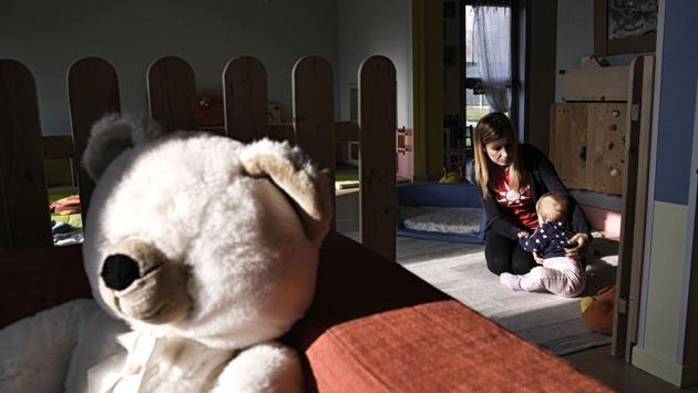 An educator plays with a child in the nursery of Bollate Penitentiary, in Milan. The arrival of the local kids created a positive effect, their presence making the nursery more attractive for staff and since December 2016, the prison has run a section to accommodate female inmates and their very young children, who have also joined in. (Marco Bertorello / AFP) An educator plays with a child in the nursery of Bollate Penitentiary, in Milan. The arrival of the local kids created a positive effect, their presence making the nursery more attractive for staff and since December 2016, the prison has run a section to accommodate female inmates and their very young children, who have also joined in. (Marco Bertorello / AFP)