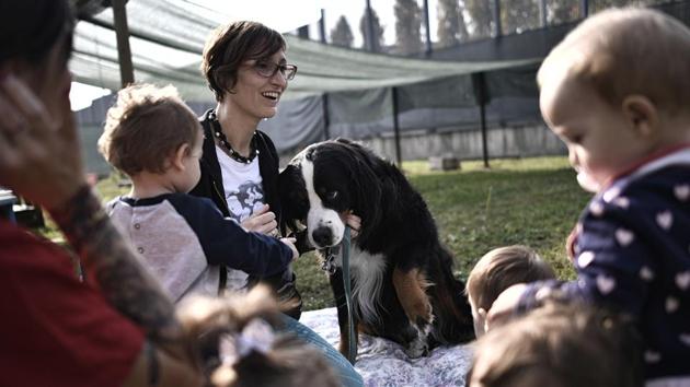 Children meet a dog during an exercise at the Bollate Penitentiary nursery, on October 12, 2017 in Italy. Located in the grounds of Milan’s medium security Bollate prison, a novel kindergarten welcomes the children of detainees, guards and local residents to what staff describe as an innovative and successful social experiment. (Marco Bertorello / AFP) Children meet a dog during an exercise at the Bollate Penitentiary nursery, on October 12, 2017 in Italy. Located in the grounds of Milan’s medium security Bollate prison, a novel kindergarten welcomes the children of detainees, guards and local residents to what staff describe as an innovative and successful social experiment. (Marco Bertorello / AFP)